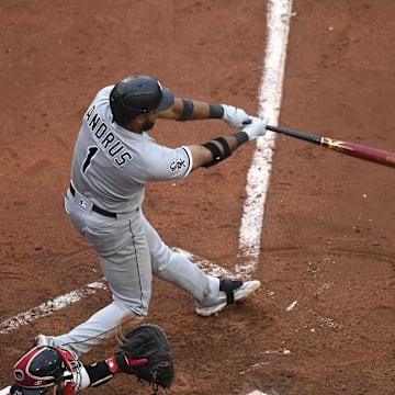 Chicago White Sox shortstop Elvis Andrus (1) hits an RBI double during the fifth inning against the Boston Red Sox at Fenway Park in 2023.