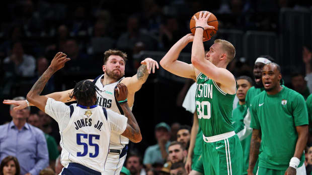 Boston Celtics forward Sam Hauser shoots a three over Luka Doncic and Derrick Jones in Game 5 of the 2024 NBA Finals.
