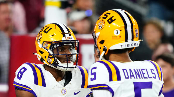 Nov 4, 2023; Tuscaloosa, Alabama, USA; LSU Tigers wide receiver Malik Nabers (8) celebrates his 46 yard touchdown with quarterback Jayden Daniels (5) against the Alabama Crimson Tide during the first quarter at Bryant-Denny Stadium.  