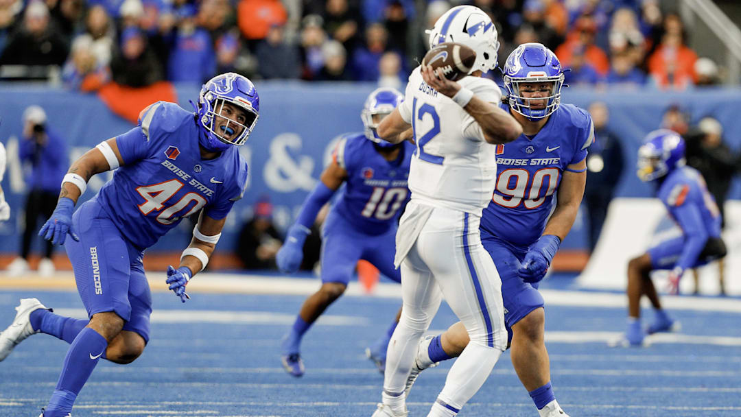 Nov 24, 2023; Boise, Idaho, USA;  Boise State Broncos defensive end Jayden Virgin (40) and defensive tackle Braxton Fely (90) pressure Air Force Falcons quarterback John Busha (12) during the second half at Albertsons Stadium. Boise State defeats Air Force 27-19. Mandatory Credit: Brian Losness-Imagn Images


