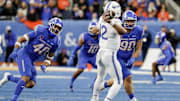Nov 24, 2023; Boise, Idaho, USA;  Boise State Broncos defensive end Jayden Virgin (40) and defensive tackle Braxton Fely (90) pressure Air Force Falcons quarterback John Busha (12) during the second half at Albertsons Stadium. Boise State defeats Air Force 27-19. Mandatory Credit: Brian Losness-Imagn Images

