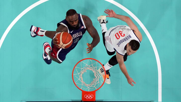Jul 28, 2024; Villeneuve-d'Ascq, France; United States guard LeBron James (6) shoots against Serbia point guard Aleksa Avramovic (30) in the first quarter during the Paris 2024 Olympic Summer Games at Stade Pierre-Mauroy. 
