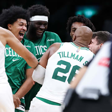 Oct 15, 2025; Boston, Massachusetts, USA; Boston Celtics center Xavier Tillman (26) celebrates with teammates after defeating the Toronto Raptors at TD Garden. Mandatory Credit: Paul Rutherford-Imagn Images