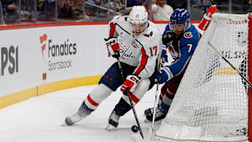 Nov 15, 2024; Denver, Colorado, USA; Washington Capitals center Dylan Strome (17) and Colorado Avalanche defenseman Devon Toews (7) battle for the puck in the third period at Ball Arena. Mandatory Credit: Isaiah J. Downing-Imagn Images