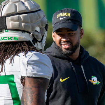 New Oregon running backs coach Ra’Shaad Samples talks with running back Jordan James during practice with the Oregon Ducks Tuesday, April 9, 2024, at the Hatfield-Dowlin Complex in Eugene, Ore.