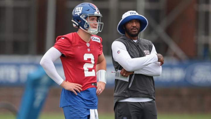 Jul 24, 2024; East Rutherford, NJ, USA; New York Giants quarterback Drew Lock (2) and assistant quarterback coach Christian Jones look on during training camp at Quest Diagnostics Training Facility.  