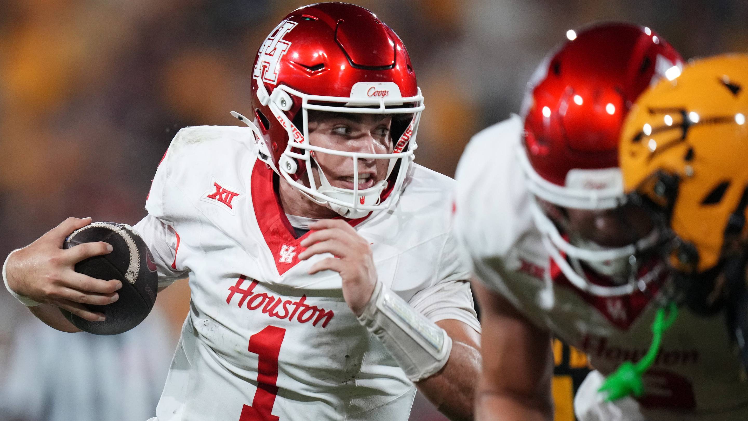 Oct 25, 2025; Tempe, Arizona, USA; Houston Cougars quarterback Conner Weigman (1) scrambles with the ball as they play against the ASU Sun Devils at Mountain America Stadium in Tempe on Oct. 25, 2025.