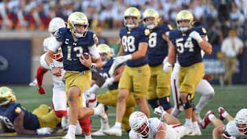 Sep 21, 2024; South Bend, Indiana, USA; Notre Dame Fighting Irish quarterback Riley Leonard (13) runs for a touchdown in the fourth quarter against the Miami Redhawks at Notre Dame Stadium. Mandatory Credit: Matt Cashore-Imagn Images
