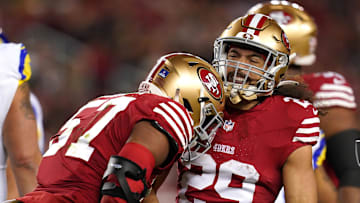 San Francisco 49ers linebacker Dre Greenlaw (57) is congratulated by safety Talanoa Hufanga (29)