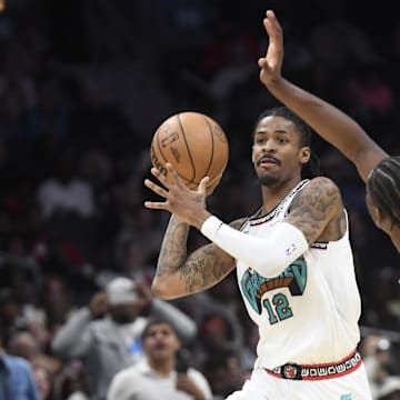 Apr 8, 2025; Charlotte, North Carolina, USA;  Memphis Grizzlies guard Ja Morant (12) looks to pass as he is defended by Charlotte Hornets forward Moussa Diabate (14) during the second half at the Spectrum Center. Mandatory Credit: Sam Sharpe-Imagn Images