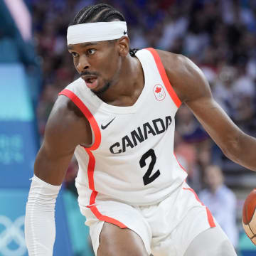 Aug 2, 2024; Villeneuve-d'Ascq, France;  Canada guard Shai Gilgeous-Alexander (2) controls the ball against Spain small forward Alex Abrines (21)