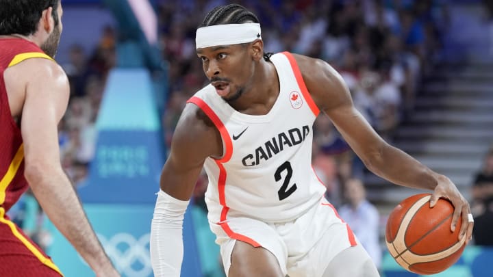 Aug 2, 2024; Villeneuve-d'Ascq, France;  Canada guard Shai Gilgeous-Alexander (2) controls the ball against Spain small forward Alex Abrines (21)