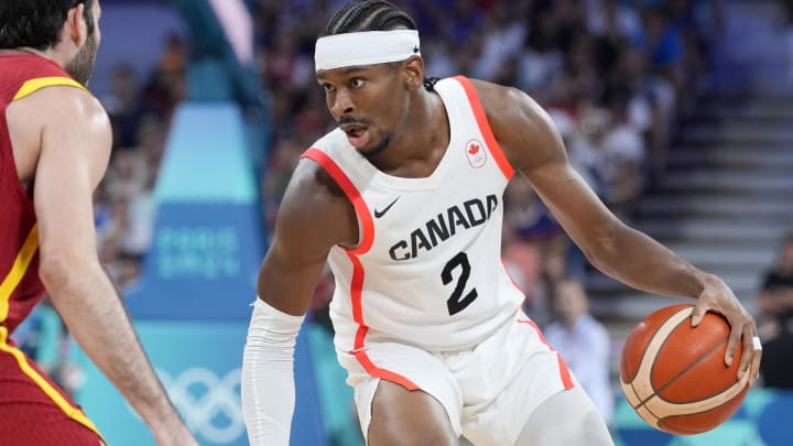 Aug 2, 2024; Villeneuve-d'Ascq, France;  Canada guard Shai Gilgeous-Alexander (2) controls the ball against Spain small forward Alex Abrines (21) in the second half in a men’s group A basketball game during the Paris 2024 Olympic Summer Games at Stade Pierre-Mauroy. Mandatory Credit: John David Mercer-USA TODAY Sports