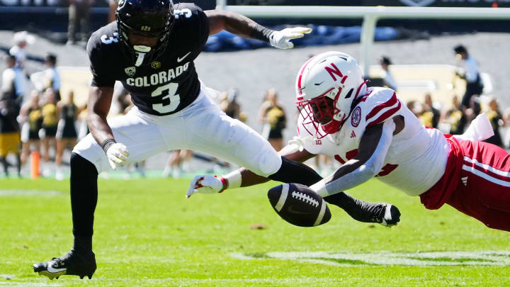 Sep 9, 2023; Boulder, Colorado, USA; Colorado Buffaloes running back Dylan Edwards (3) and Nebraska Cornhuskers defensive back Omar Brown (12) reach for the ball in the second quarter at Folsom Field. 