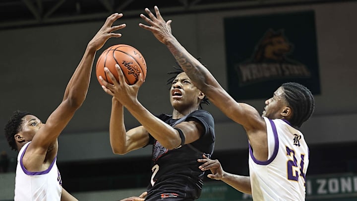 Lakota West's Joshua Tyson (2) drive to the basket Reynodsburg's Jordan Fisher and Toby Nwokolo during the Firebirds' loss on March 16, 2025.