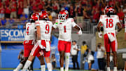 Utah Utes running back Wayshawn Parker (1) celebrates his touchdown scored against the UCLA Bruins with wide receiver Ryan Davis (9) and quarterback Devon Dampier (4) during the first half at Rose Bowl.