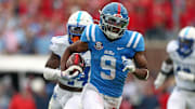 Mississippi Rebels wide receiver Tre Harris (9) runs after a catch for a first down as Kentucky Wildcats defensive back Jordan Lovett (25) pursues during the second half at Vaught-Hemingway Stadium. 