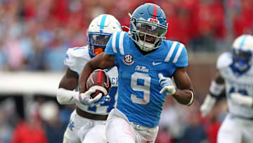 Mississippi Rebels wide receiver Tre Harris (9) runs after a catch for a first down as Kentucky Wildcats defensive back Jordan Lovett (25) pursues during the second half at Vaught-Hemingway Stadium. 