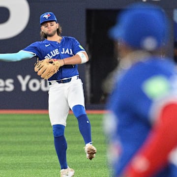 Jul 2, 2024; Toronto, Ontario, CAN;  Toronto Blue Jays shortstop Bo Bichette (11) commits a throwing error on a ball hit by Houston Astros left fielder Yordan Alvarez (not shown) in the eighth inning at Rogers Centre.