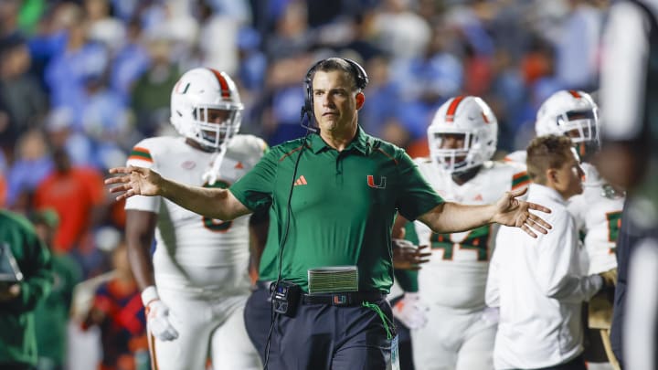 Oct 14, 2023; Chapel Hill, North Carolina, USA; Miami Hurricanes head coach Mario Cristobal stands on the field during a timeout as the Hurricanes play against the North Carolina Tar Heels in the second half at Kenan Memorial Stadium. Mandatory Credit: Nell Redmond-USA TODAY Sports