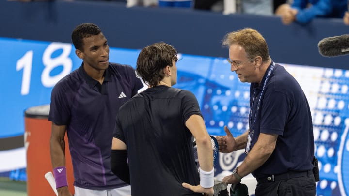 Aug 16, 2024; Cincinnati, OH, USA; Felix Auger-Aliassime of Canada and Jack Draper of Great Britain meet at the net after a controversial match-ending point is explained by ATP Tour supervisor Roland Herbal on Day 5 of the Cincinnati Open.