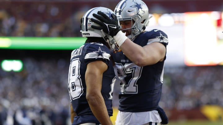 Jan 7, 2024; Landover, Maryland, USA; Dallas Cowboys wide receiver Jalen Tolbert (18) celebrates with Cowboys tight end Jake Ferguson (87) after catching a touchdown pass against the Washington Commanders during the first quarter at FedExField. 