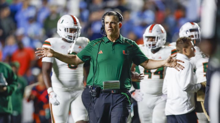 Oct 14, 2023; Chapel Hill, North Carolina, USA; Miami Hurricanes head coach Mario Cristobal stands on the field during a timeout as the Hurricanes play against the North Carolina Tar Heels in the second half at Kenan Memorial Stadium. Mandatory Credit: Nell Redmond-USA TODAY Sports