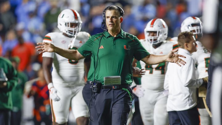 Oct 14, 2023; Chapel Hill, North Carolina, USA; Miami Hurricanes head coach Mario Cristobal stands on the field during a timeout as the Hurricanes play against the North Carolina Tar Heels in the second half at Kenan Memorial Stadium. Mandatory Credit: Nell Redmond-USA TODAY Sports