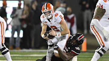Nov 14, 2025; Louisville, Kentucky, USA;  Louisville Cardinals defensive lineman Clev Lubin (50) sacks Clemson Tigers quarterback Cade Klubnik (2) during the first half at L&N Federal Credit Union Stadium. Mandatory Credit: Jamie Rhodes-Imagn Images