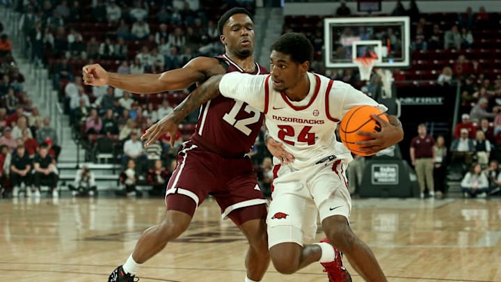 Feb 7, 2026; Starkville, Mississippi, USA; Arkansas Razorbacks wing Billy Richmond III (24) drives to the basket as Mississippi State Bulldogs guard Josh Hubbard (12) defends during the first half at Humphrey Coliseum. Mandatory Credit: Petre Thomas-Imagn Images