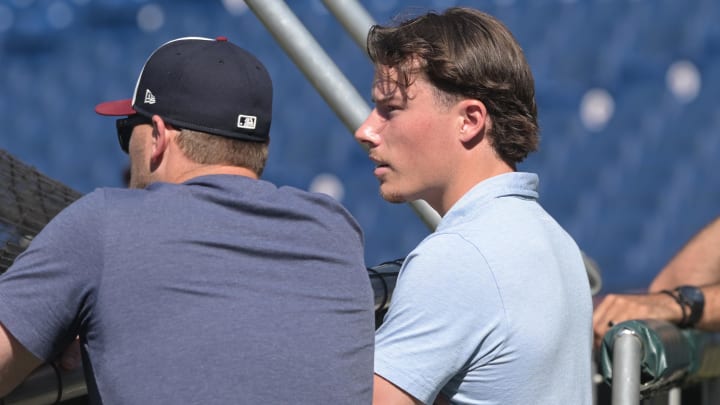 Jul 19, 2024; Cleveland, Ohio, USA; Cleveland Guardians number one draft pick Travis Bazzana, right watches batting practice before the game between the Cleveland Guardians and the San Diego Padres at Progressive Field. Mandatory Credit: Ken Blaze-USA TODAY Sports