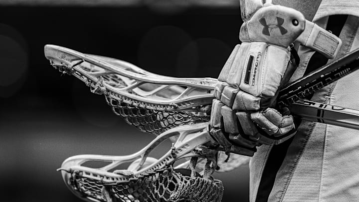 May 27, 2024; Philadelphia, PA, USA; (photo converted to black and white) Notre Dame fighting Irish player holds gloves and lacrosse sticks before a game against the Maryland Terrapins at Lincoln Financial Field. Mandatory Credit: Bill Streicher-Imagn Images May 27, 2024; Philadelphia, PA, USA; (photo converted to black and white) Notre Dame fighting Irish player holds gloves and lacrosse sticks before a game against the Maryland Terrapins at Lincoln Financial Field. Mandatory Credit: Bill Streicher-Imagn Images
