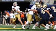 Notre Dame Fighting Irish quarterback Riley Leonard looks to throw the ball against the Navy Midshipmen.