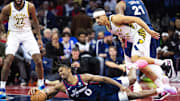 Nov 14, 2023; Philadelphia, Pennsylvania, USA; Philadelphia 76ers guard Tyrese Maxey (0) dives for a ball in front of Indiana Pacers guard Andrew Nembhard (2) during the third quarter at Wells Fargo Center. Mandatory Credit: Bill Streicher-Imagn Images