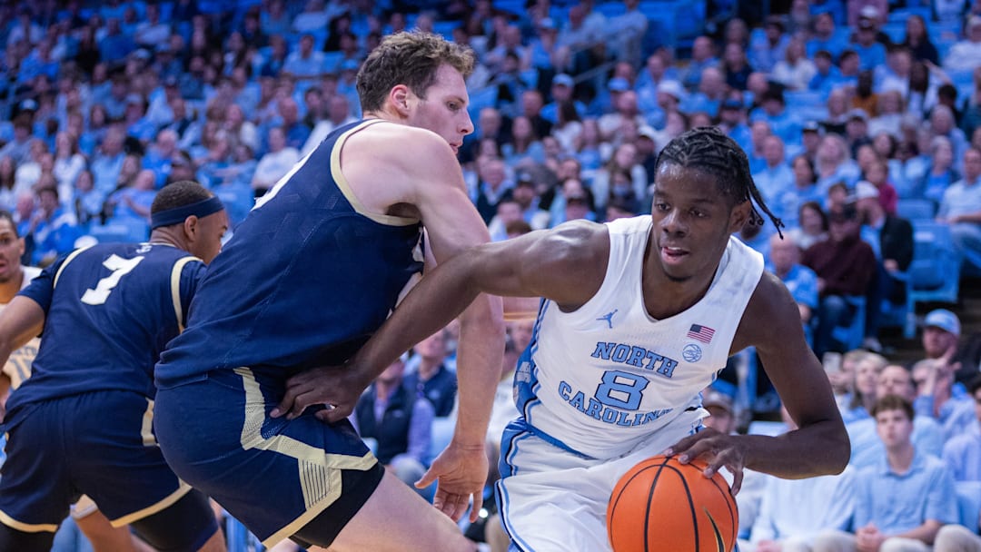 Nov 18, 2025; Chapel Hill, North Carolina, USA; North Carolina Tar Heels forward Caleb Wilson (8) drives on Navy Midshipmen center Aidan Kehoe (99) during the second half at Dean E. Smith Center. 
