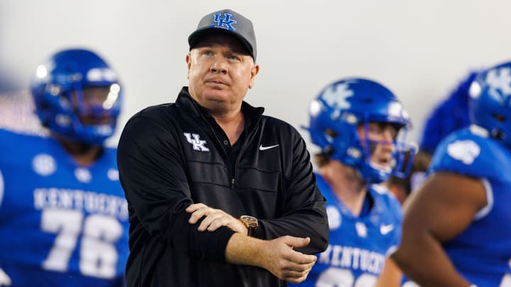 Sep 16, 2023; Lexington, Kentucky, USA; Kentucky Wildcats head coach Mark Stoops runs onto the field before the game against the Akron Zips at Kroger Field. Mandatory Credit: Jordan Prather-USA TODAY Sports