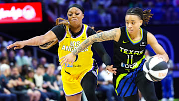 Jun 6, 2025; Arlington, Texas, USA;  Dallas Wings guard JJ Quinerly (11) dribbles past Los Angeles Sparks guard Odyssey Sims (0) during the second half at College Park Center. Mandatory Credit: Kevin Jairaj-Imagn Images