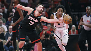 Nov 21, 2025; Houston, Texas, USA; Houston Rockets center Alperen Sengun (28) attempts to get control of the ball away from Denver Nuggets guard Peyton Watson (8) during the third quarter at Toyota Center. Mandatory Credit: Troy Taormina-Imagn Images