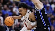 Mar 22, 2025; Denver, CO, USA; Wisconsin Badgers guard John Tonje (9) dribbles the ball past Brigham Young Cougars guard Dawson Baker (25) during the first half in the second round of the NCAA Tournament  at Ball Arena.