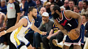 Apr 13, 2025; San Francisco, California, USA; Golden State Warriors guard Stephen Curry (30) defends against LA Clippers guard James Harden (1) as referee Jacyn Goble (68) watches the play during the second quarter at Chase Center. Mandatory Credit: Robert Edwards-Imagn Images