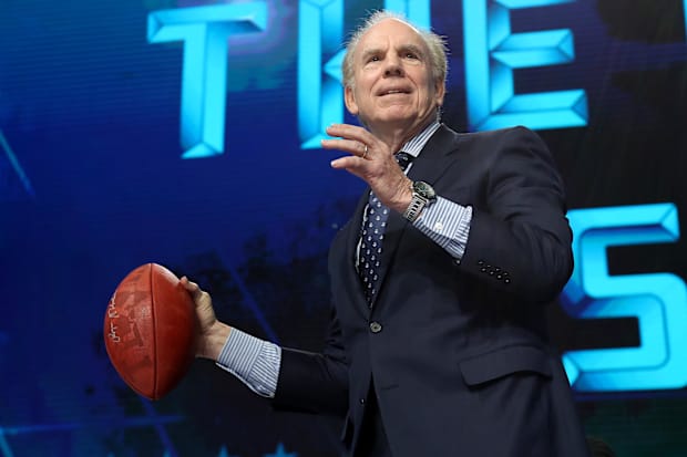 Dallas Cowboys quarterback Roger Staubach throws a football from the stage prior to the first round of the 2018 NFL Draft. 