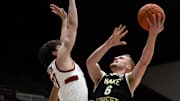 Feb 5, 2025; Stanford, California, USA; Wake Forest Demon Deacons guard Cameron Hildreth (6) goes up for a shot against Stanford Cardinal forward Evan Stinson (33) during the first half at Maples Pavilion. Mandatory Credit: D. Ross Cameron-Imagn Images