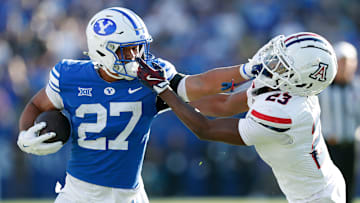 BYU RB LJ Martin stiff arms an Arizona defender as the Cougars handled the Wildcats.
