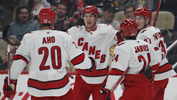 Oct 18, 2024; Pittsburgh, Pennsylvania, USA;  Carolina Hurricanes center Sebastian Aho (20) and center Seth Jarvis (24) and right wing Andrei Svechnikov (37) congratulate center Martin Necas (88) on his goal against the Pittsburgh Penguins during the second period at PPG Paints Arena. Mandatory Credit: Charles LeClaire-Imagn Images