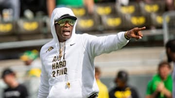 Deion Sanders walks the field during warmups before Colorado's game against Oregon.