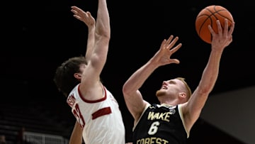 Feb 5, 2025; Stanford, California, USA; Wake Forest Demon Deacons guard Cameron Hildreth (6) goes up for a shot against Stanford Cardinal forward Evan Stinson (33) during the first half at Maples Pavilion. Mandatory Credit: D. Ross Cameron-Imagn Images