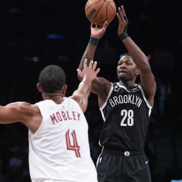 Mar 21, 2023; Brooklyn, New York, USA; Brooklyn Nets forward Dorian Finney-Smith (28) shoots the ball against Cleveland Cavaliers forward Evan Mobley (4) during the second half at Barclays Center. Mandatory Credit: Vincent Carchietta-USA TODAY Sports