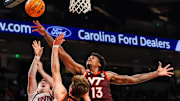 Dec 2, 2025; Columbia, S.C.; Virginia Tech forward Amani Hansberry (13) grabs a rebound over South Carolina guard Eli Ellis (15).