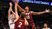 Dec 2, 2025; Columbia, South Carolina, USA; Virginia Tech Hokies forward Amani Hansberry (13) grabs a rebound over South Carolina Gamecocks guard Eli Ellis (15) in the first half at Colonial Life Arena. Mandatory Credit: Jeff Blake-Imagn Images