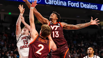 Dec 2, 2025; Columbia, South Carolina, USA; Virginia Tech Hokies forward Amani Hansberry (13) grabs a rebound over South Carolina Gamecocks guard Eli Ellis (15) in the first half at Colonial Life Arena. Mandatory Credit: Jeff Blake-Imagn Images